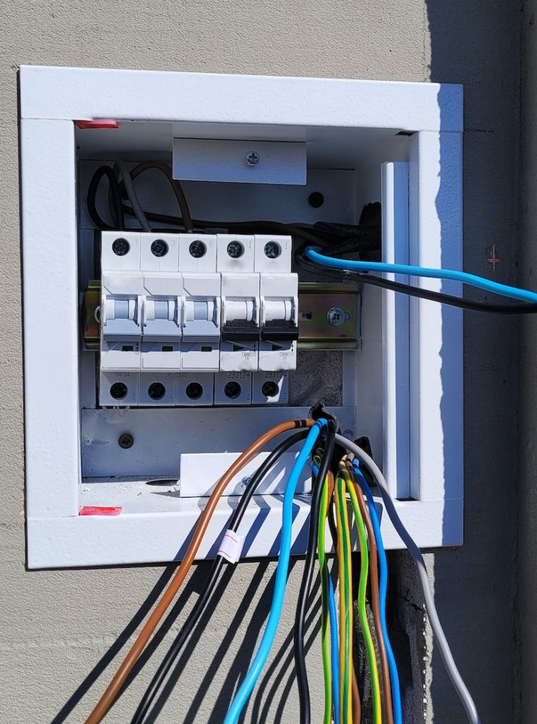 electricity distribution box with wires and circuit breakers